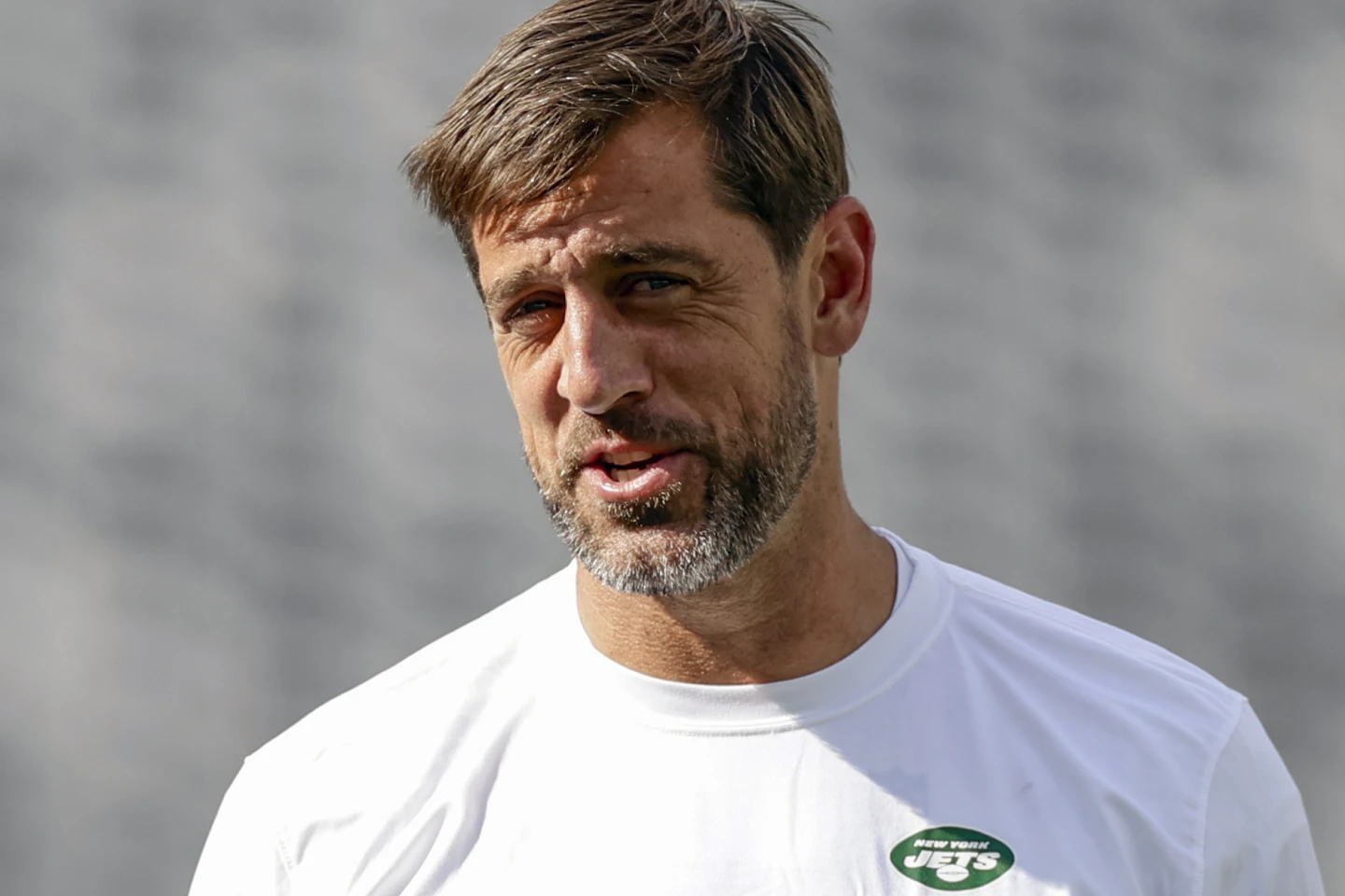 New York Jets quarterback Aaron Rodgers (above), injured in the team's season opener against Buffalo, is going through rehab, but is doing so on his own time frame, he recently told friend Pat McAfee. (Photo by ADAM HUNGER - COURTESY OF THE ASSOCIATED PRESS)