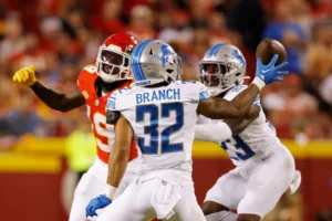 Detroit defensive back Brian Branch (32) pulls a ball in and intercepts it against Kansas City in the NFL season opener Thursday night. Branch returned the interception for a touchdown, and the Lions upset Patrick Mahomes and the Chiefs, 21-20. (Photo courtesy of DAVID EULITT / GETTY IMAGES)