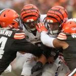 Cincinnati Bengals quarterback Joe Burrow is tackled by Cleveland Browns defensive end Ogbo Okoronkwo. Burrow had an NFL career-low 82 passing yards as he and the Bengals lost to Cleveland, 24-3. (Photo courtesy of SAM GREENE – THE CINCINNATI ENQUIRER)