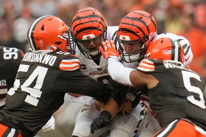 Cincinnati Bengals quarterback Joe Burrow is tackled by Cleveland Browns defensive end Ogbo Okoronkwo. Burrow had an NFL career-low 82 passing yards as he and the Bengals lost to Cleveland, 24-3. (Photo courtesy of SAM GREENE – THE CINCINNATI ENQUIRER)