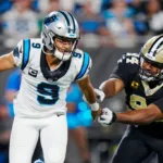 Carolina quarterback Bryce Young (9) is harassed by New Orleans Saints defensive end Cam Jordan (94) last Monday. Young sprained an ankle in the game and has been ruled out for this Sunday's game at Seattle. Also ruled out: Indy quarterback Anthony Richardson (concussion) for the Colts' game at Baltimore. (Photo courtesy of YAHOO! SPORTS)