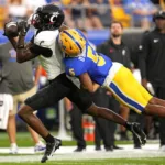 Cincinnati wide receiver Dee Wiggins caught this pass in front of Pittsburgh defensive back Phillip O’Brien Jr. (5) in their game on Sept. 9. The Bearcats (3-1) host Oklahoma in the Big 12 Conference opener for both teams on Saturday. (Photo by GENE J. PUSKAR, Courtesy of THE ASSOCIATED PRESS)