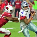 Dallas Cowboys quarterback Dak Prescott (right) tries to avoid Arizona linebacker Jesse Luketa. Prescott and the Cowboys couldn't avoid the upset Sunday, though, as the Cardinals got their first win of the season, a 28-16 victory over Dallas. (Photo courtesy of USA TODAY)