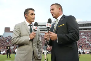 Chris Fowler (left) and Kirk Herbstreit, considered ESPN-ABC's number one college football announce team, won't be calling Colorado-Oregon this Saturday. Instead, they've been assigned to LSU-Arkansas. It could be the duties that both men have taken on that have impacted ESPN's decision. (Photo courtesy of FOOTBALLSCOOP.COM)