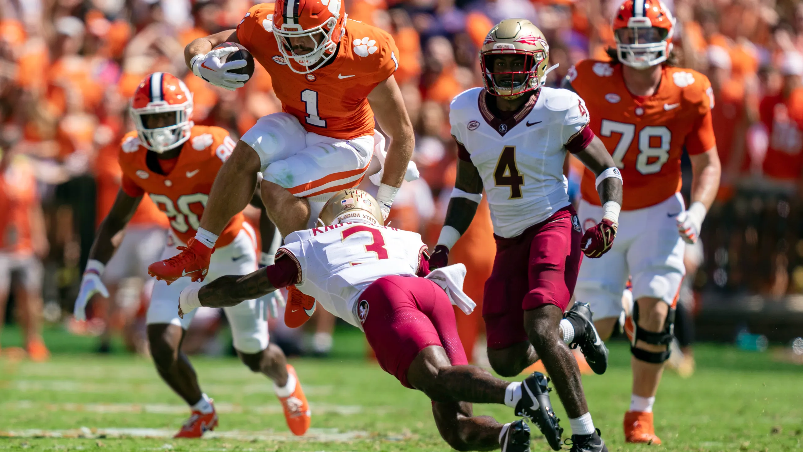 Clemson's Will Shipley (1) tries to vault Florida State linebacker Kevin Knowles. Florida State won the ACC showdown, beating the Tigers, 31-24 in overtime (Photo courtesy WRBL.COM)