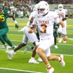 Texas quarterback Quinn Ewers (3) scrambles for yards against Baylor. The Longhorns won big at Baylor Saturday night, 38-6. (Photo by DENNIS JACOBS)