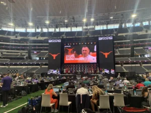 The "jumbotron" that hovers above the turf at AT&T Stadium in Arlington announces the arrival of Texas coach Steve Sarkisian during the Big 12 Conference's media days in July. The Big 12 Conference opens its schedule Saturday, and the Longhorns, ranked third in the nation, play Baylor in Waco. (Photo by MITCH LUCAS)