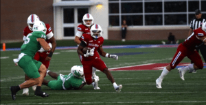 Louisiana Tech's Tyre Shelton (4, center) breaks free for yards against North Texas Saturday night in a game in Ruston, La. Shelton had 152 rush yards and a touchdown, but Tech came up short, 40-37. (Photo by ALEX NABOR)