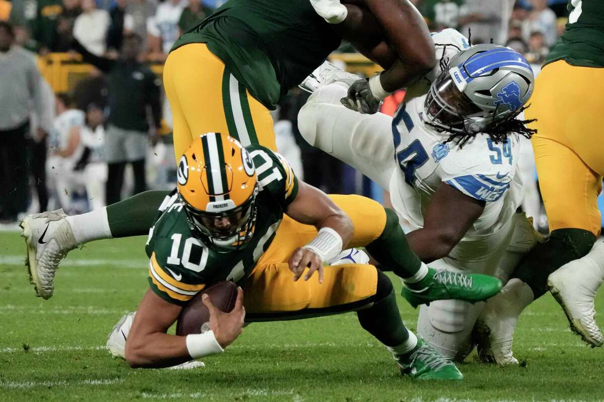 Green Bay Packers quarterback Jordan Love (10) is shown being sacked by Detroit Lions defensive tackle Alim McNeill (right) during the first half Thursday night at Lambeau Field in Green Bay, Wis. Lions running back David Mongtomery scored three touchdowns and Detroit had 211 rushing yards to take a 34-20 win. (Photo courtesy of THE ASSOCIATED PRESS)