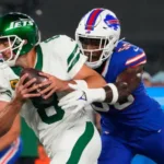 New York Jets quarterback Aaron Rodgers is sacked by Buffalo's Leonard Floyd. Rodgers was injured on the play and is believed to be out for the entire 2023 season. He had surgery Wednesday, ESPN has reported, but told friend Pat McAfee on Friday that he would return, even at 40. (Photo courtesy of BLEACHERNATION.COM)