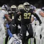 New Orleans Saints defensive lineman Malcolm Roach celebrates a tackle on Tennessee Titans running back Derrick Henry. The Saints would hold off the Titans, 16-15, at the Caesars Superdome; Titans quarterback Ryan Tannehill threw three interceptions. (Photo courtesy of DAVID GRUNFELD – THE TIMES-PICAYUNE)
