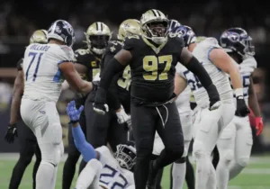 New Orleans Saints defensive lineman Malcolm Roach celebrates a tackle on Tennessee Titans running back Derrick Henry. The Saints would hold off the Titans, 16-15, at the Caesars Superdome; Titans quarterback Ryan Tannehill threw three interceptions. (Photo courtesy of DAVID GRUNFELD – THE TIMES-PICAYUNE)