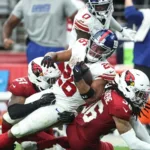 New York Giants running back Saquon Barkley (top) was injured (sprained ankle) on this play Sunday, and will miss at the very least this Thursday's game at San Francisco. The 49ers may miss wide receiver Brandon Aiyuk in the game (questionable with a shoulder injury). (Photo courtesy of BROBIBLE.COM)