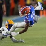 Florida’s Aidan Mizell (right) is tackled by McNeese State defensive back Twillie Lovett last weekend in Gainesville. The Gators (1-1) host Tennessee (2-0) Saturday night at 6 p.m. on ESPN in an SEC East Division battle. (Photo by JOHN RAOUX – Courtesy of the Associated Press)