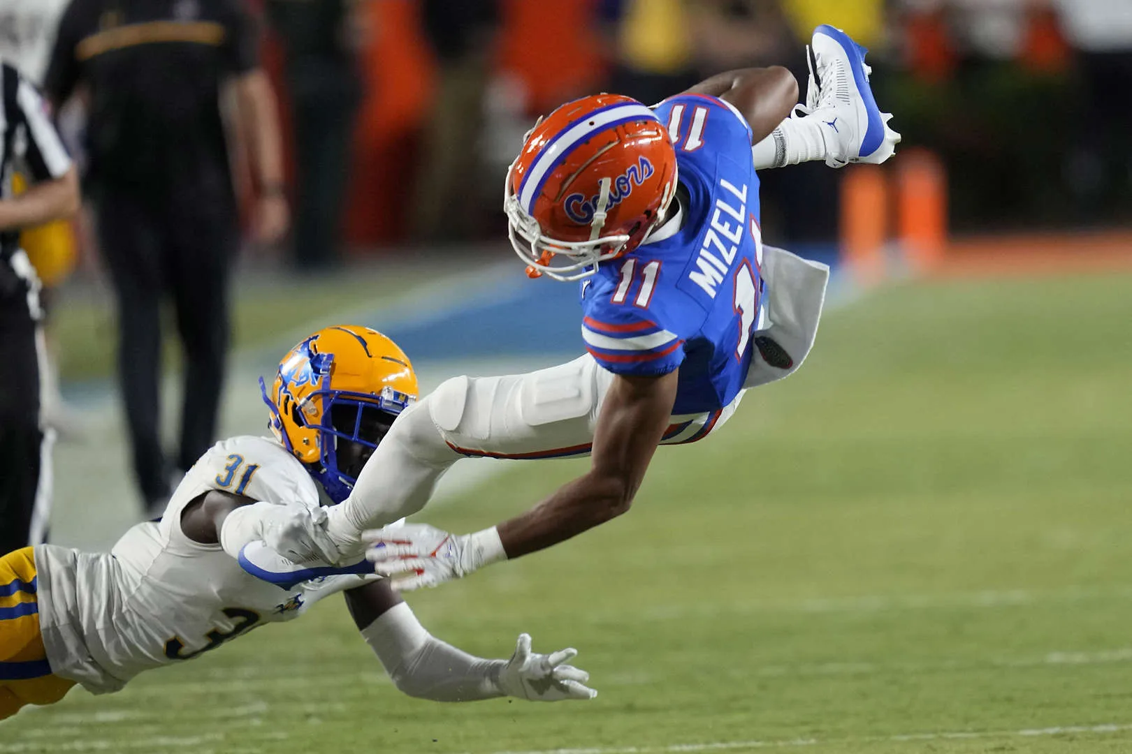 Florida’s Aidan Mizell (right) is tackled by McNeese State defensive back Twillie Lovett last weekend in Gainesville. The Gators (1-1) host Tennessee (2-0) Saturday night at 6 p.m. on ESPN in an SEC East Division battle. (Photo by JOHN RAOUX – Courtesy of the Associated Press)