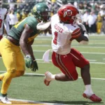 Running back Jaylon Glover (right) scores on an 11-yard touchdown for Utah to give the Utes a 20-13 win at Baylor on Saturday. (Photo couresty of DESERET.COM)