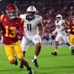Southern Cal quarterback Caleb WIlliams (left) outran Arizona defenders to the end zone for a two-point conversion here, to escape an upset bid by the Wildcats. Southern Cal won in triple overtime, 43-41. (Photo courtesy of USATODAY.COM)