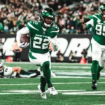 New York Jets corner Tony Smith (22) grabs an interception thrown by Philadelphia quarterback Jalen Hurts late in Sunday's game. The Jets would take the lead right after that, and win the game, 20-14. (Photo courtesy of NEWYORKJETS.COM)