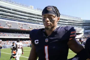 Chicago Bears quarterback Justin Fields (1) leaves Soldier Field after a 31-28 loss to Denver, a game the Bears led by three scores. Fields and the Bears visit Washington tonight, a 7 p.m. start. (Photo by NAM Y. HUH - Courtesy of THE ASSOCIATED PRESS)