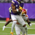 Minnesota Vikings receiver Justin Jefferson (foreground) makes a catch Sunday against Kansas City safety Justin Reid. But Jefferson left the game in the fourth quarter with a strained hamstring, one that will now require him to be placed on injured reserve. (Photo by BRUCE KLUCKHOHN, courtesy of THE ASSOCIATED PRESS)