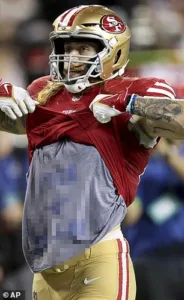 San Francisco tight end George Kittle (above) unveils a Dallas T-shirt with an expletive on it, during the 49ers' 42-10 win over the Cowboys on Sunday night. (Photo courtesy of THE ASSOCIATED PRESS)