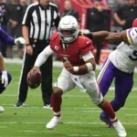 Arizona quarterback Kyler Murray (center) was to return to practice on Wednesday for the first time since tearing an ACL last December 12. (Photo courtesy of SPORTINGNEWS.COM)