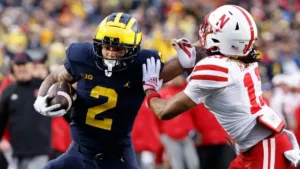 Michigan running back Blake Corum (left) had two touchdowns Saturday in a 52-7 win over Indiana. (Photo courtesy of CBSSPORTS.COM)