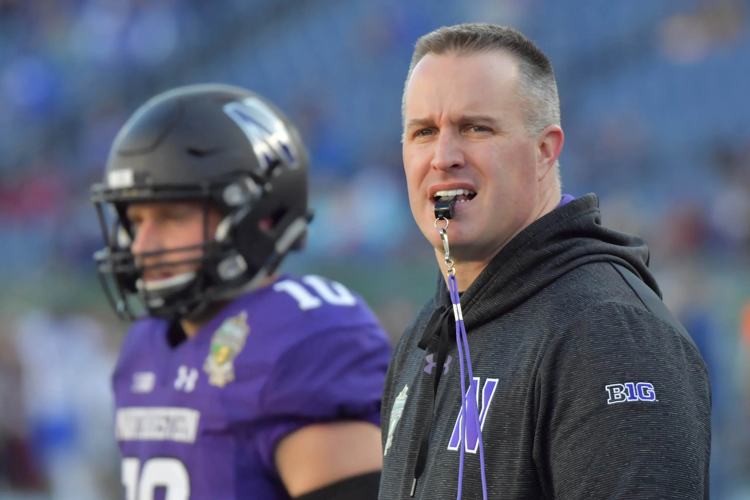 Former Northwestern football coach Pat Fitzgerald (above, right) has filed a $130 million lawsuit against the university for wrongful termination. (Photo courtesy of SATURDAYTRADITION.COM)