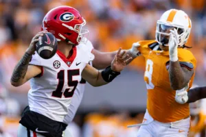 Georgia quarterback Carson Beck (left) avoids the Tennessee pass rush to throw the ball. Beck and the Bulldogs (12-0) will face No. 8 Alabama (11-1) Saturday at 3 p.m. on CBS in the Southeastern Conference Championship Game. (Photo courtesy of CHRISTIANINDEX.COM)