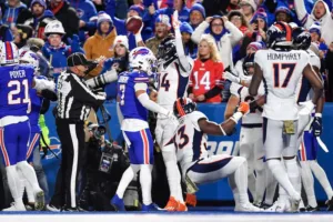 Denver receiver Courtland Sutton (center) signals touchdown, and he was proven correct, in the first half after making an incredible toe-drag catch at Buffalo, an eventual 24-22 Broncos win. (Photo courtesy of THE ASSOCIATED PRESS)