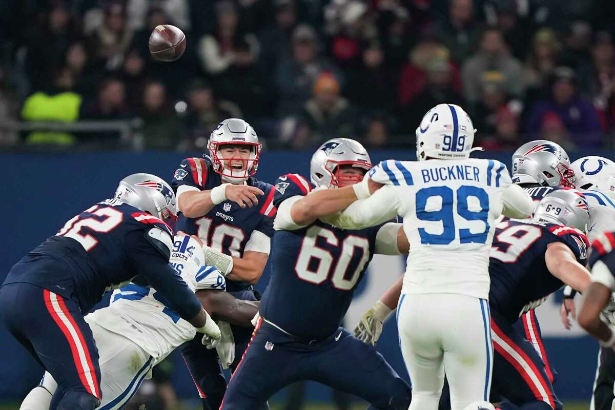 New England quarterback Mac Jones (background) hurls a pass against the Indianapolis Colts in Frankfurt, Germany. Jones hasn't exactly lit the world on fire this season, and the Patriots are 2-8 and at the bottom of the AFC East. Coach Bill Belichick on Tuesday wouldn't say if Jones would start Sunday vs. the New York Giants or if it would be Bailey Zappe. (Photo courtesy of TIMES-UNION.COM)