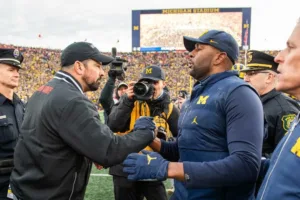 Ohio State coach Ryan Day (left) shakes hands with Michigan interim coach and offensive coordinator Sherrone Moore after Michigan 30-24 win on Saturday in Ann Arbor. (Photo from REDDIT)