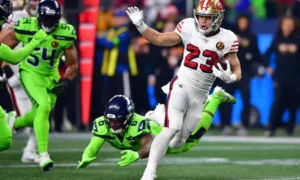 San Francisco running back Christian McCaffrey (23) scores a touchdown against Seattle on Thanksgiving night, in a 31-13 win over the Seahawks. (Photo by THE ASSOCIATED PRESS)