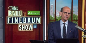 SEC Network host and longtime newspaper columnist Paul Finebaum (right) during a recent show. Finebaum appears to be caught up in a feud with former pro wrestler "Nature Boy" Ric Flair over comments Finebaum made about Michigan football and coach Jim Harbaugh. (Photo courtesy of NEWSCASTSTUDIO.COM)