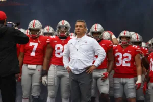 Could they? WOULD they? Would the administration at Texas A&M University seek to hire retired national-championship-winning coach Urban Meyer (above, with Ohio State) as their next head football coach? (Photo by CASEY CASCALDO, THE LANTERN)