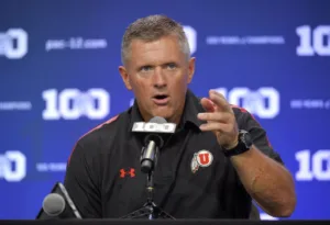 Utah coach Kyle Whittingham (above) and the Utes will compete in the Big 12 Conference next season, where 16 teams will play (none of them named Texas or Oklahoma). (Photo courtesy of M-LIVE.COM)