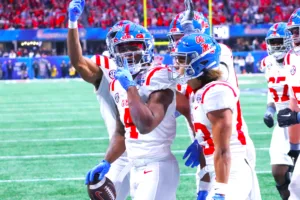 Ole Miss running back Quinshon Judkins (4) celebrates after scoring on a 14-yard pass from teammate Jaxson Dart. Ole Miss (11-2) rocked Penn State, 38-25, in the Chick-Fil-A Peach Bowl on Saturday in Atlanta. (Photo by DENNIS JACOBS - THEFOOTBALLBEAT.COM