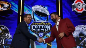 Missouri head coach Eli Drinkwitz (left) and Ohio State's Ryan Day shake hands after the head coaches' press conference for the 88th Goodyear Cotton Bowl Classic on Thursday. The Tigers (10-2) will take on the Ohio State Buckeyes (11-1) on Friday night at 7 p.m. on ESPN and ESPN+. (Photo courtesy of Cotton Bowl staff)