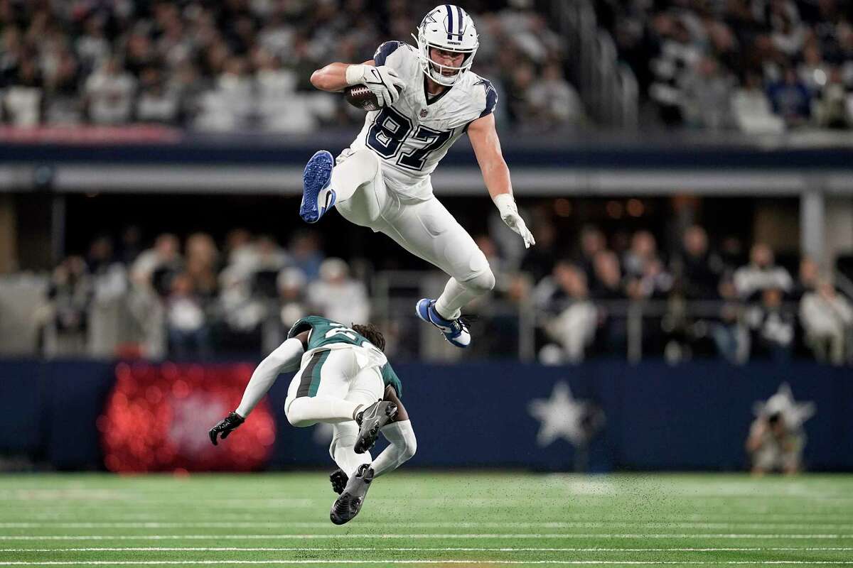 Dallas Cowboys tight end Jake Ferguson (top) leaps a tackle attempt by Philadelphia's Kelee Ringo. Dallas dealt the Eagles a second straight loss, 33-13, on Sunday night, knocking the Eagles from the top of the NFC and the NFC East standings. (Photo by SAM HODDE; Courtesy of THE ASSOCIATED PRESS)