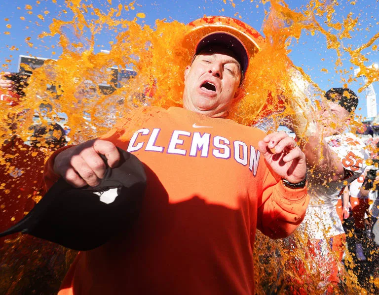 Clemson coach Dabo Swinney is doused with Clemson-covered Gatorade after the Tigers came back for a 38-35 win over Kentucky in the TaxSlayer Gator Bowl. (Photo courtesy of BVMSPORTS.COM)