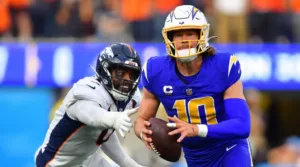 A broken index finger on his throwing hand will sideline Los Angeles Chargers quarterback Justin Herbert (right), who will miss the rest of the season after having surgery. (Photo courtesy of WEIS.COM)