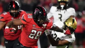 Texas Tech senior running back Tahj Brooks (center) has 2,957 career rushing yards and 27 touchdowns as a Red Raider. He's hoping to add more tonight, as Tech (6-6) takes on Cal (6-6) in the Radiance Technologies Independence Bowl, the prime-time game Saturday night on ESPN, an 8:15 p.m. kickoff. (Photo by ANNIE RICE, Courtesy of the LUBBOCK AVALANCHE-JOURNAL)