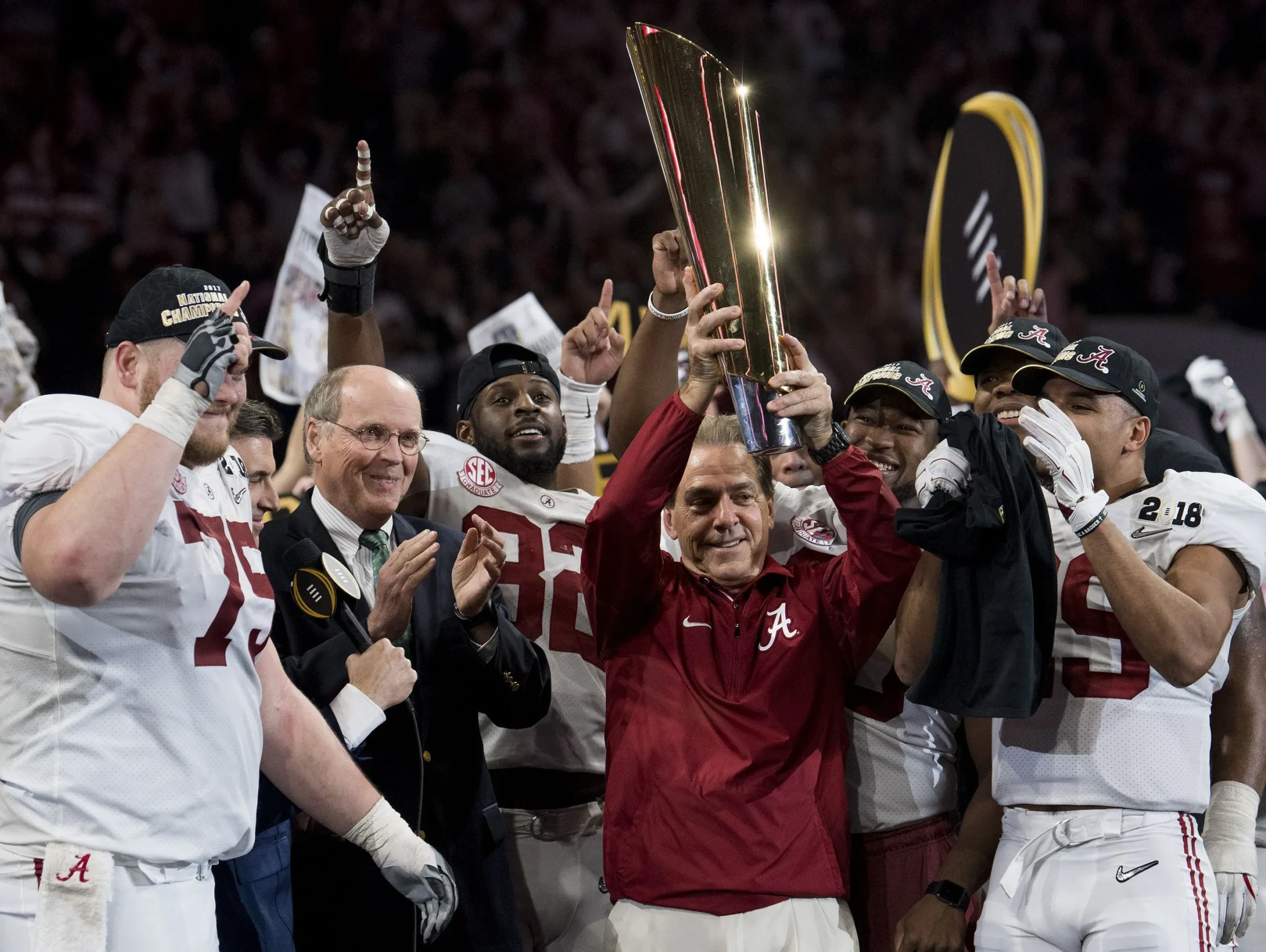 Alabama's Nick Saban, with one of his seven national title trophies, six at 'Bama. Saban announced his retirement on Wednesday, sending shockwaves throughout the sports world. (Photo courtesy of USATODAY.COM)