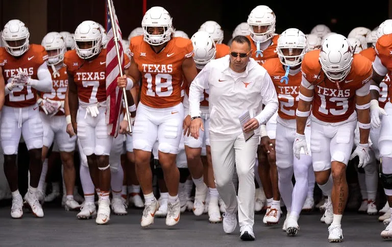 Texas coach Steve Sarkisian (right front) is about to agree to a four-year extension that will double his salary to $10 million a year and keep him in Austin through 2030. (Photo courtesy of MSN.COM)