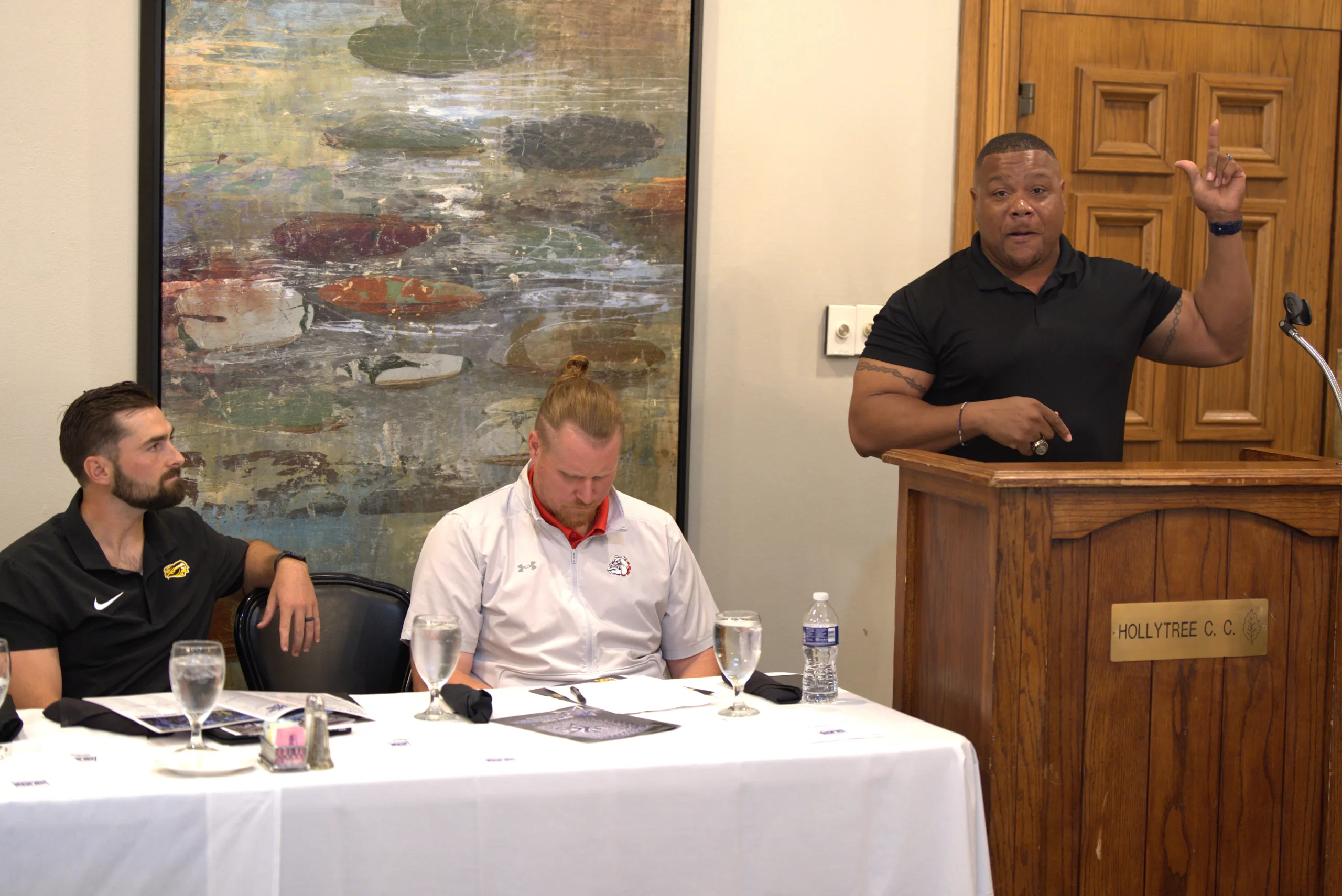 Kilgore College head football coach Willie Gooden (right) talks to the media as fellow head coaches Tanner Jacobson (left, Tyler Junior College) and Ryan Taylor (Navarro, center), listen during Southwest Junior College Football Conference Media Day last Thursday at Hollytree Country Club at Tyler, Texas. Gooden and the Kilgore College Rangers have won the Texas football conference the last two seasons, and reached the final four in the nation last year, losing to Iowa Western in the semifinals. (Photo by MITCH LUCAS - THE FOOTBALL BEAT)