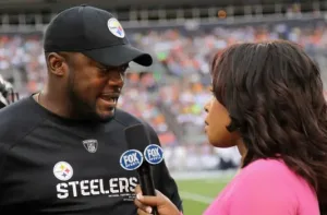 FOX Sports reporter Pam Oliver speaks with Pittsburgh Steelers head coach Mike Tomlin after a game. Now, the league is requiring its head coaches to speak to sideline media (presumably the network covering the game) either during the first half or the second half each week, beginning this season. (Photo courtesy of THE DENVER POST)