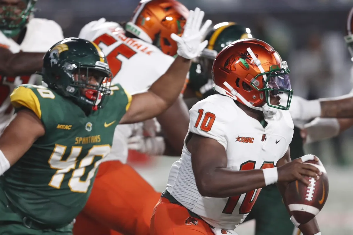 Florida A&M quarterback Daniel Richardson (right) tries to avoid the pass rush from a Norfolk State defender in their game in Atlanta on Saturday. Richardson threw three touchdown passes, two of them to Jamari Gassett, and FAMU held off Norfolk, 24-23. (Photo courtesy of THE TALAHASSEE DEMOCRAT)