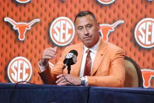 Texas coach Steve Sarkisian, who guided the Longhorns to their first-ever trip to the College Football Playoff a year ago, ponders a question at SEC Media Days in Dallas in July. Sarkisian and the 'Horns play at Michigan this Saturday at 11 a.m. on FOX. (Photo by VIRGINIA HAGLER-LUCAS - THE FOOTBALL BEAT)