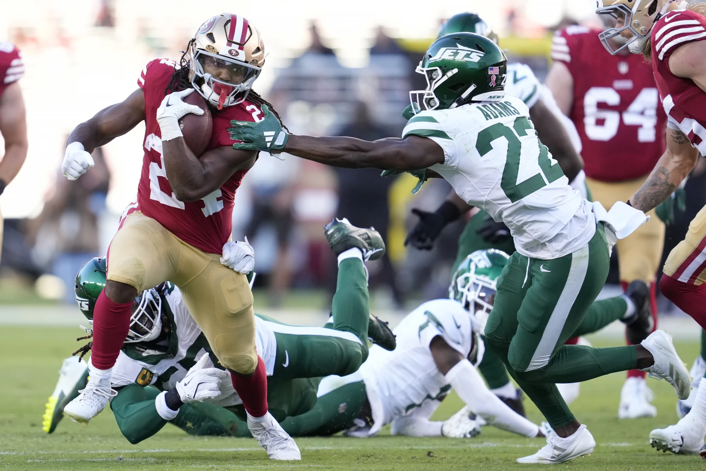 San Francisco running back Jordan Mason (24), filling in for the injured Christian McCaffrey, runs past New York Jets safety Tony Adams during a "Monday Night Football" game Sept. 9 in Santa Clara, Calif. Mason and the 49ers won, 32-19. (Photo by GODOFREDO A. VASQUEZ, courtesy of THE ASSOCIATED PRESS)