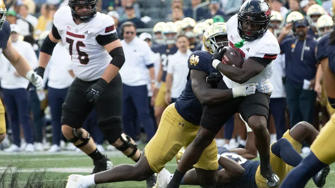 Upset of the first month of the 2024 season: Northern Illinois over Notre Dame, in South Bend, 16-14, on Saturday. Pictured: Northern Illinois running back Antario Brown is stopped by Fighting Irish defensive lineman R.J. Oben. Photo by MICHAEL CLUBB; courtesy of THE INDIANAPOLIS STAR)